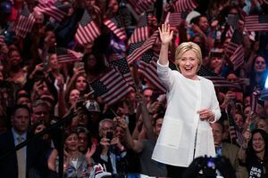 Хиллари Цлинтон маше пред гомилом људи који машу америчким заставама